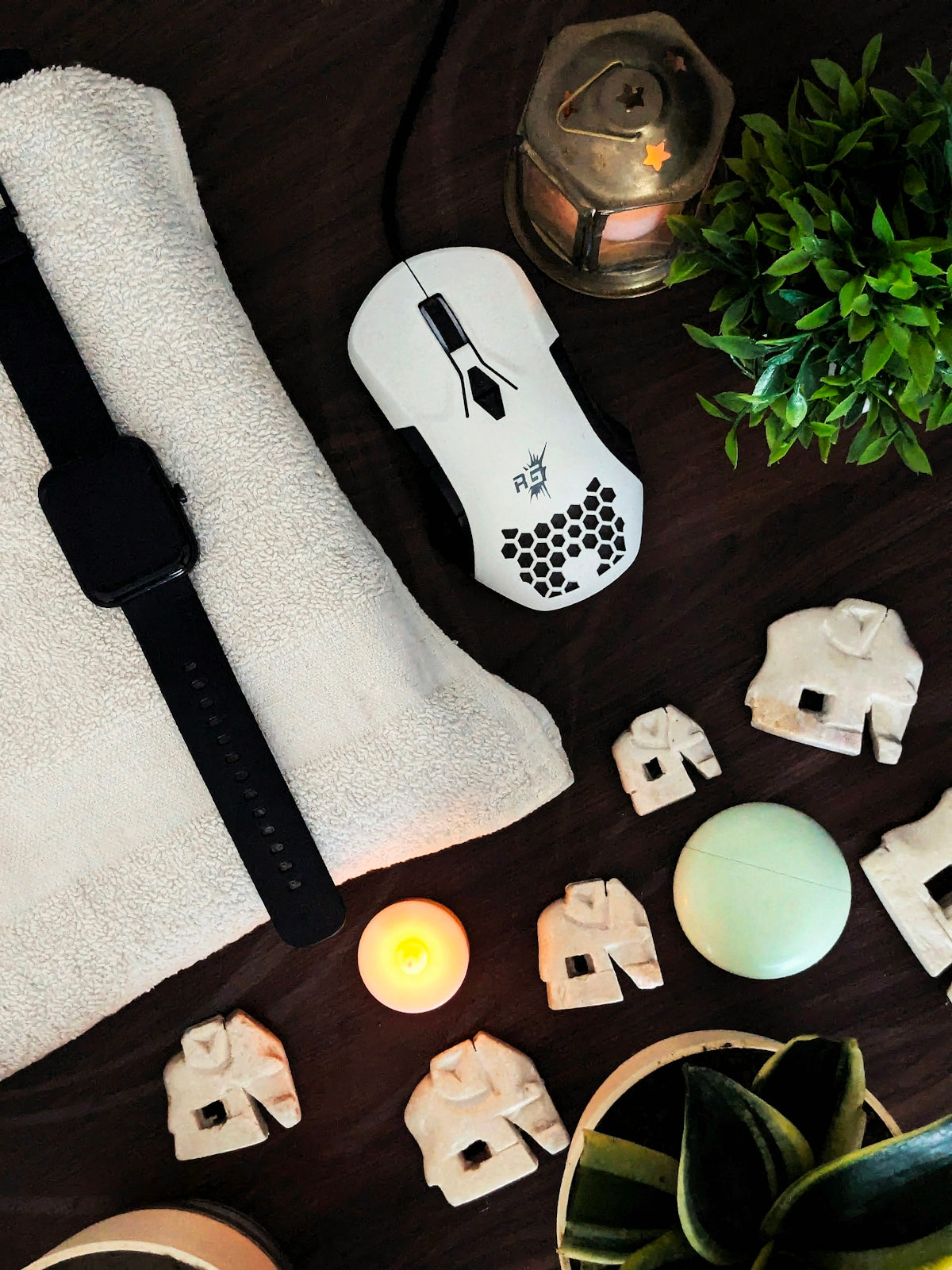 A wooden table topped with white towels and candles